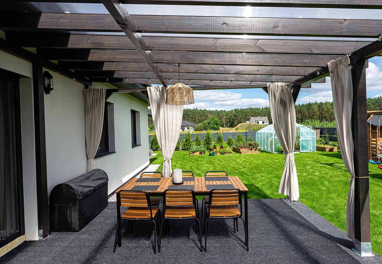 Backyard pergola with clear roof tiles over looking a lawn