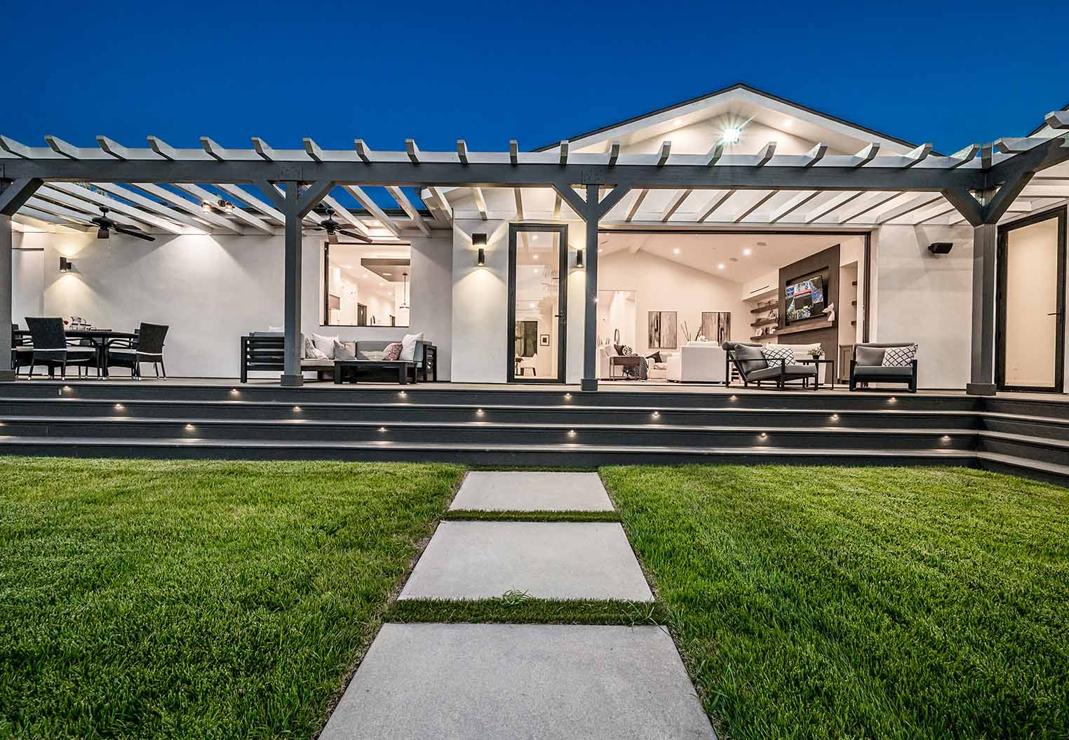 Custom new construction home with large pergola over a backyard deck