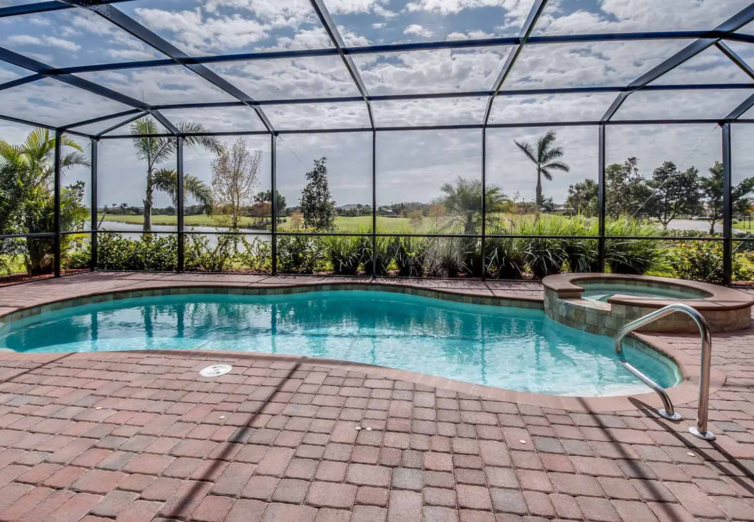 Large screened in pool patio overlooking a golf course