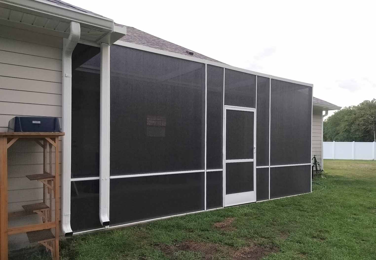 Screened in patio with dark screen and white aluminum structure