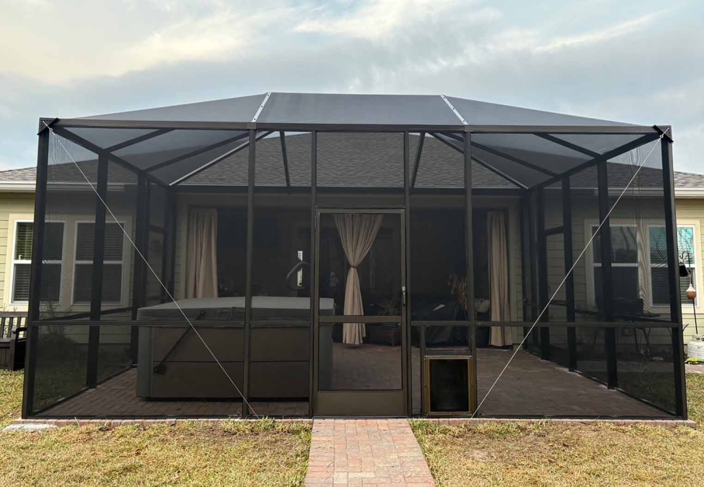custom screen enclosed patio with hottub and custom paver flooringjpg