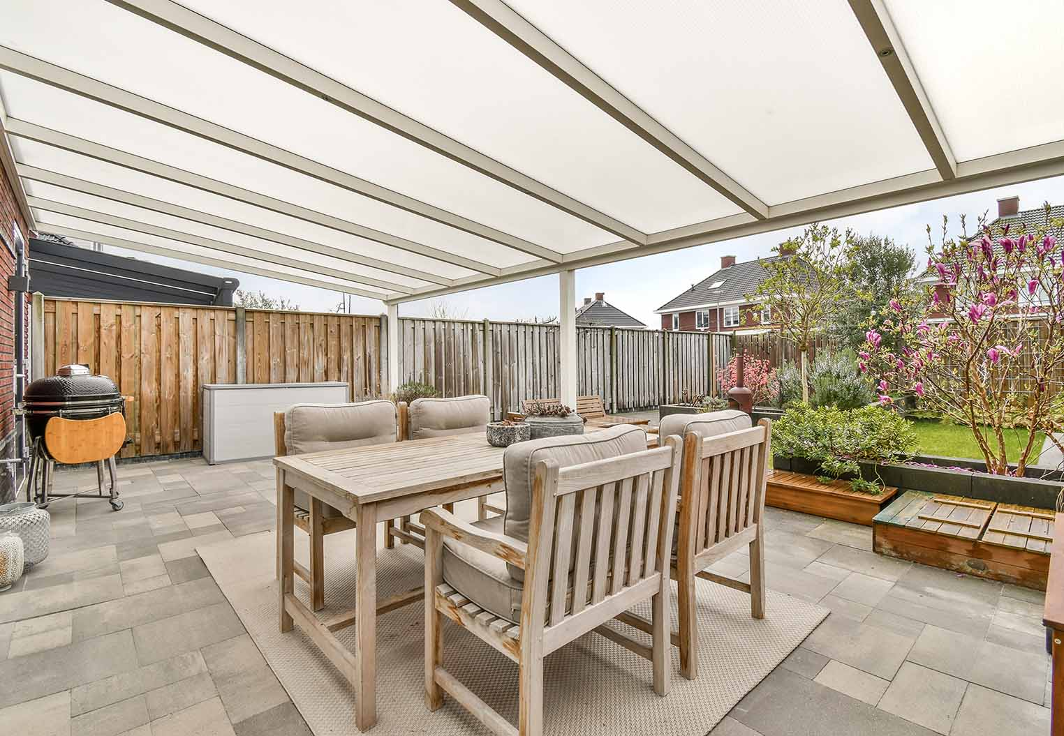fraosted patio cover over patio furniture with paver flooring