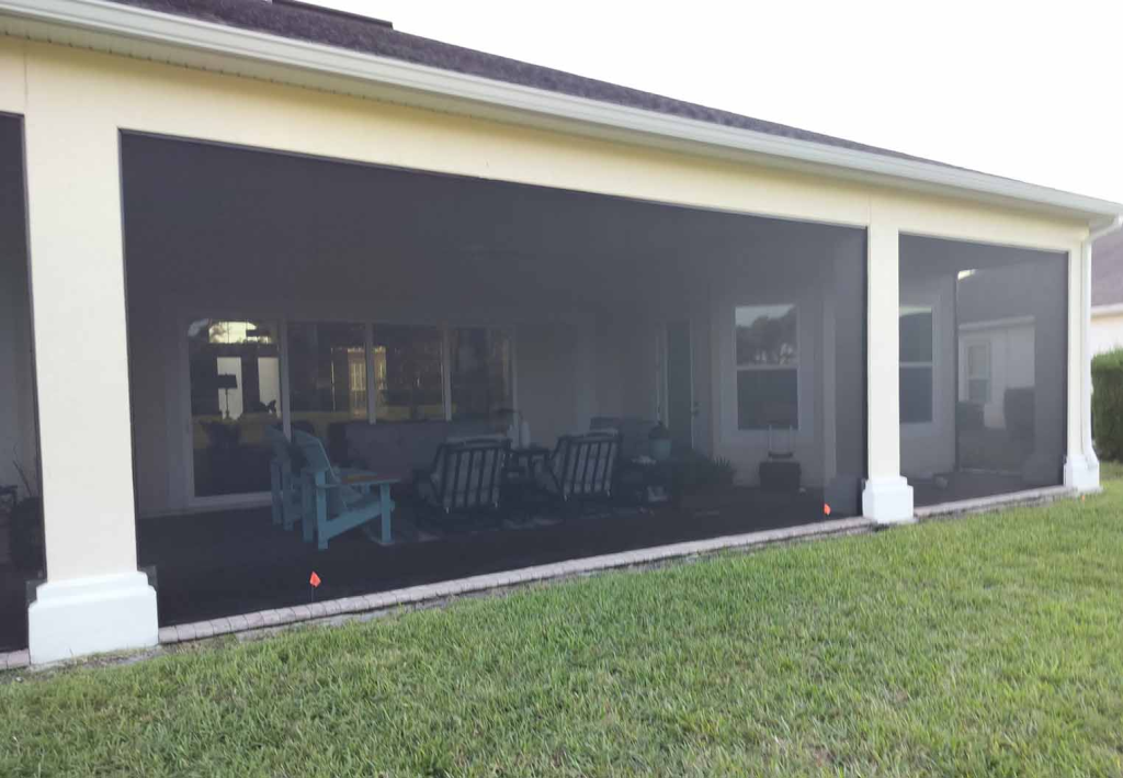 large custom screened in patio on a residetial property