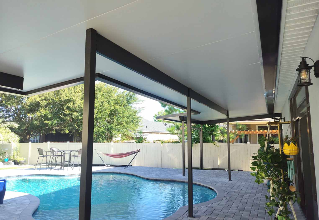 looking out uncer a new awning over pool paver pool deck in backyard