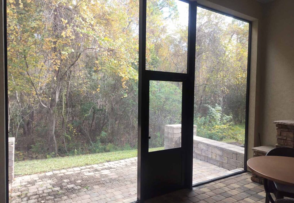 screened in patio over looking a wooded back yard