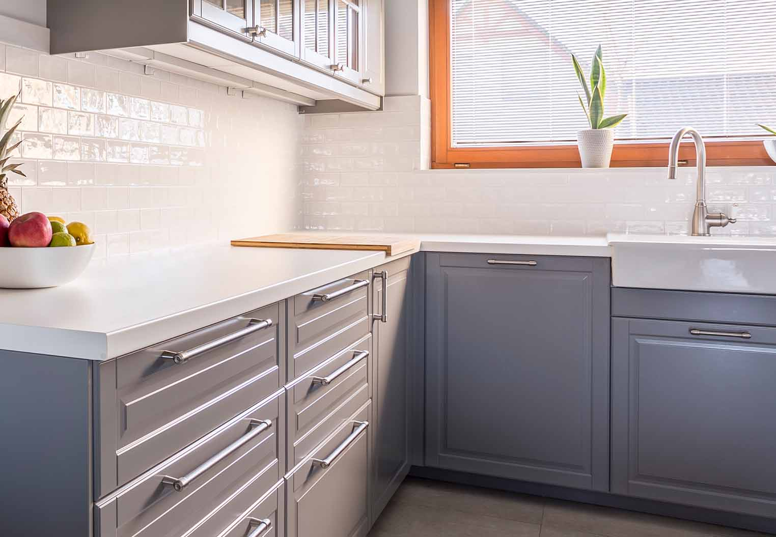contemporary kitchen with grey cabinets and white counter tops