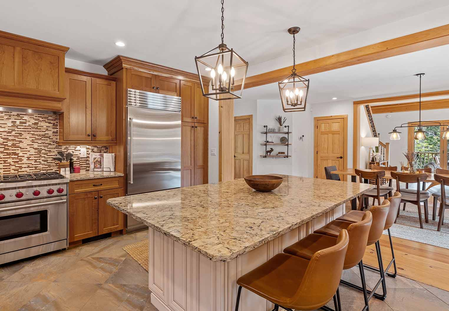 remodeled kitchen with new cabinets, granite counter tops, appliances, an island and furniture